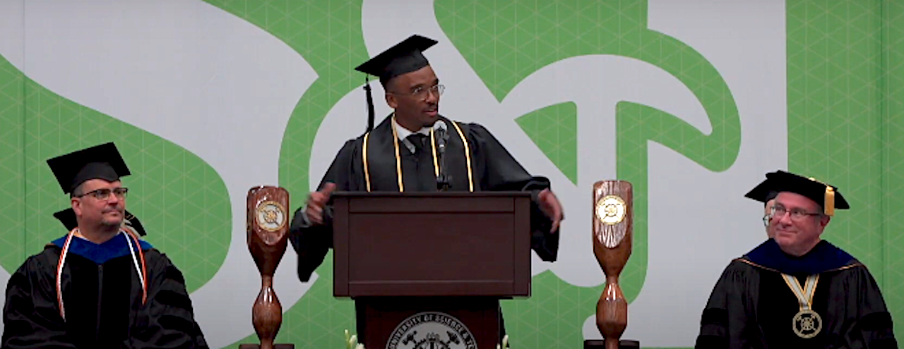 A photo of Alexander Brooks giving a commencement speech